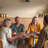 two-males-two-females-sitting-at-table-of-food-laughing